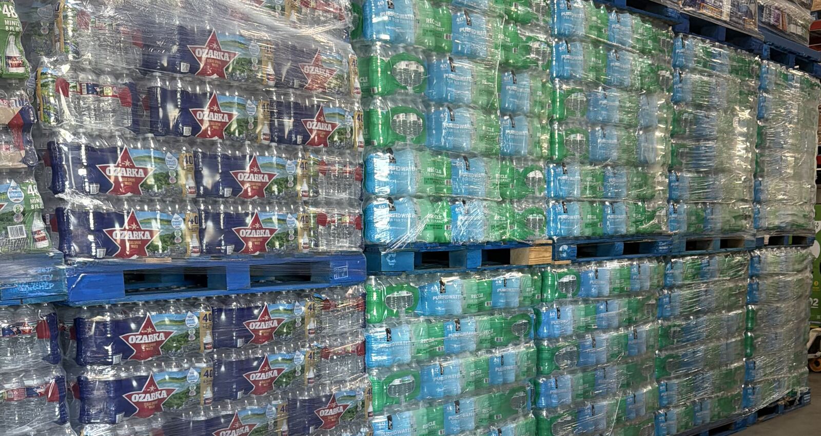 Shrink-wrapped pallets of Ozarka spring water and purified bottled water stacked and ready for delivery